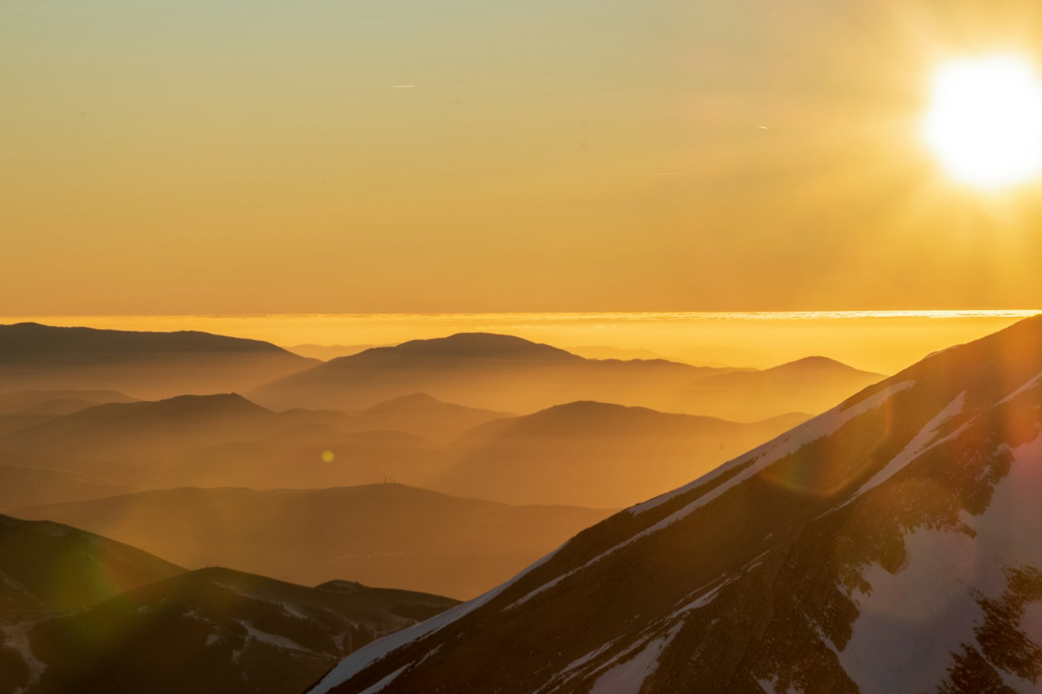 Golden sunrise over misty mountains